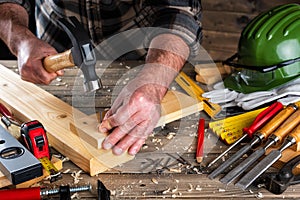 Carpenter at work on wooden boards. Carpentry