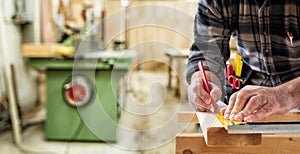 Carpenter at work on wooden boards. Carpentry