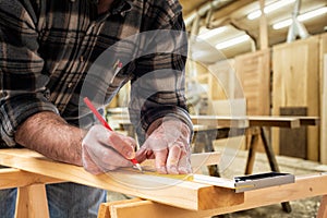 Carpenter at work on wooden boards. Carpentry