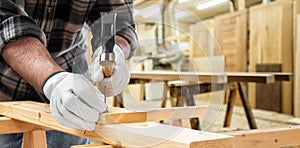 Carpenter at work on wooden boards. Carpentry