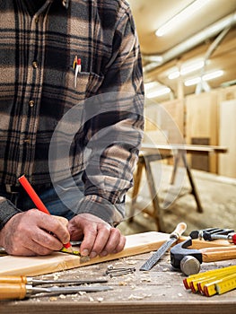 Carpenter at work on wooden boards. Carpentry