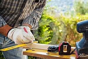 Carpenter at work on wooden boards. Carpentry