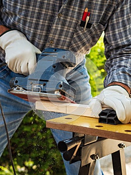 Carpenter at work on wooden boards. Carpentry