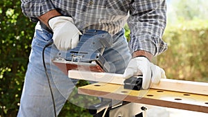 Carpenter at work on wooden boards. Carpentry.