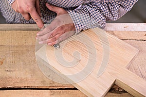 Carpenter at work. Working on wooden cutting board