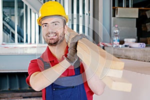 Carpenter worker holding wooden boards