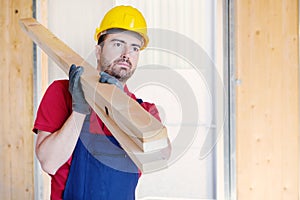 Carpenter worker holding wooden boards
