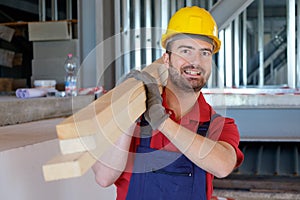 Carpenter worker holding wooden boards