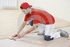 Carpenter worker joining parket floor