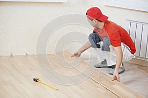 Carpenter worker joining parket floor