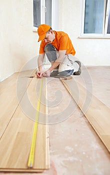 Carpenter worker joining parket floor