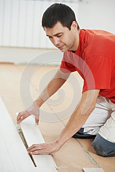 Carpenter worker joining parket floor