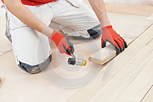 Carpenter worker joining parket floor