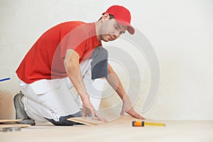 Carpenter worker joining parket floor