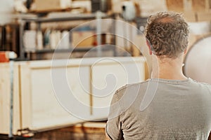 Carpenter working on a cabinet in a joinery workshop