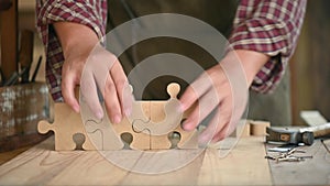 Carpenter working in carpentry shop. DIY wood puzzle for decoration