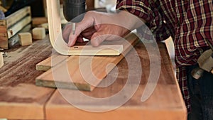 Carpenter working in carpentry shop. Woodwork for furniture and home decor making concept.