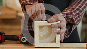 Carpenter working in carpentry shop. Woodwork for furniture and home decor making concept.