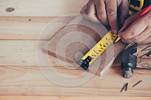 Carpenter working in carpentry shop. Woodwork for furniture and home decor making concept.