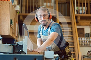 Carpenter working at the circular cutter