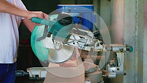 Carpenter working with circular saw to cut the wooden board