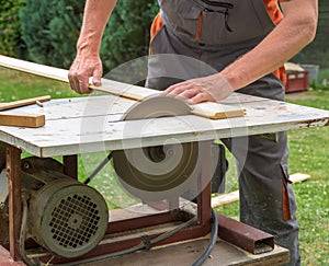 Carpenter working with electric buzz saw