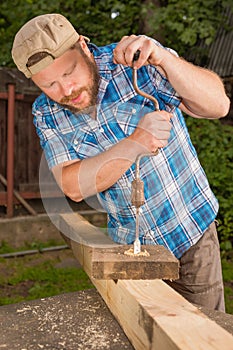 Carpenter working by hand drill