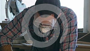 Carpenter working with Industrial tool in wood factory wearing safety glasses