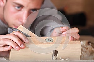 Carpenter working with plane photo