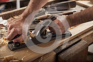 Carpenter working with plane