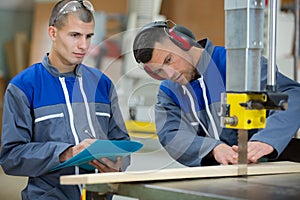 carpenter working with table saw in workshop