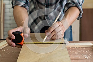 Carpenter working on wood craft at workshop