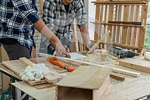 Carpenter working on wood craft at workshop