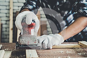 Carpenter working on wood craft at workshop