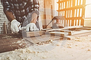 Carpenter working on wood craft at workshop