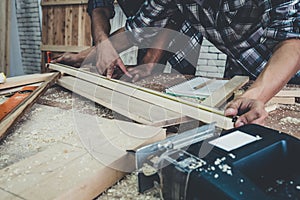 Carpenter working on wood craft at workshop