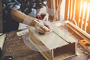 Carpenter working on wood craft at workshop