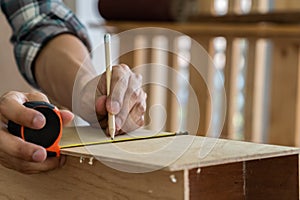 Carpenter working on wood craft at workshop