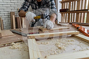 Carpenter working on wood craft at workshop