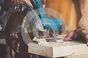 Carpenter working on wood craft at workshop