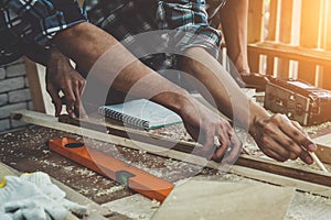 Carpenter working on wood craft at workshop