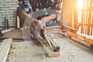 Carpenter working on wood craft at workshop