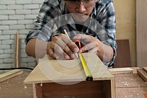 Carpenter working on wood craft at workshop