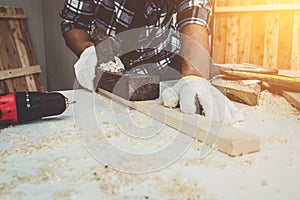 Carpenter working on wood craft at workshop