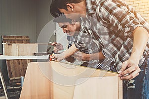 Carpenter working on wood craft at workshop