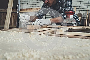 Carpenter working on wood craft at workshop