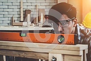 Carpenter working on wood craft at workshop