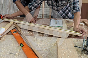 Carpenter working on wood craft at workshop