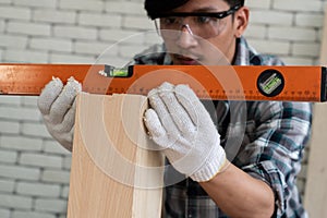 Carpenter working on wood craft at workshop