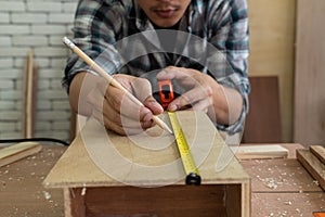Carpenter working on wood craft at workshop